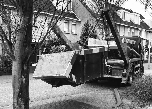 Delivery of a skip on a Fulham street showing safe placement